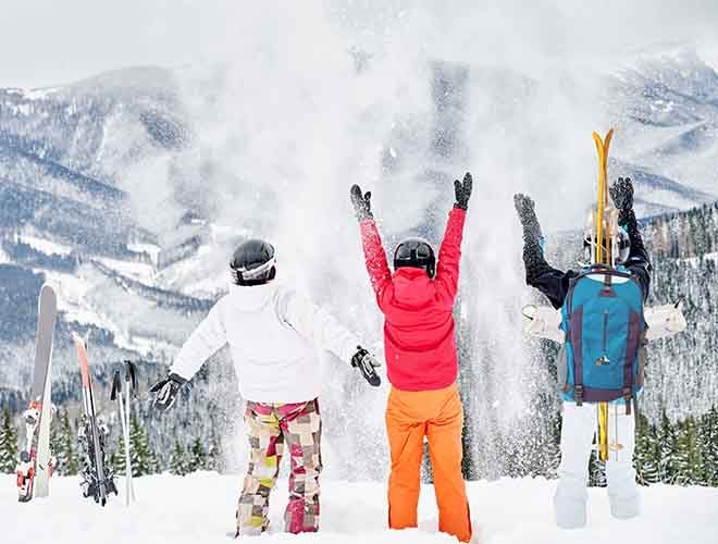 Skiers team having fun in snowy mountains.